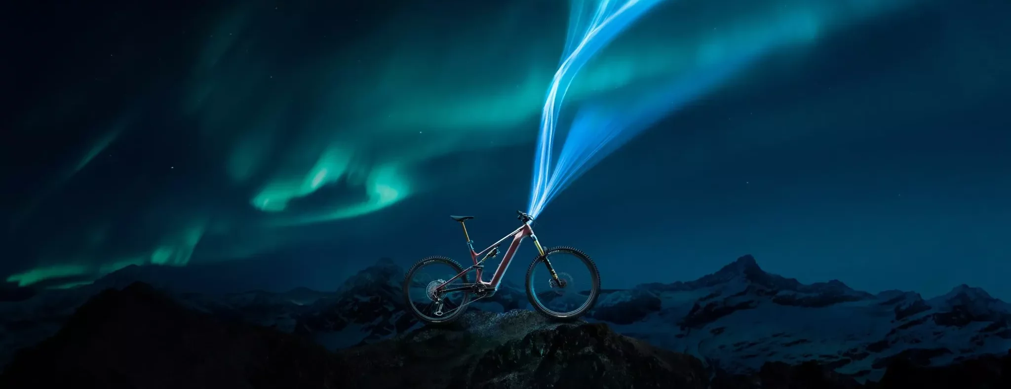 A stunning view of a Specialized e-MTB set against the northern lights. Elevate your ride with our premium mountain bike rentals in Verbier.